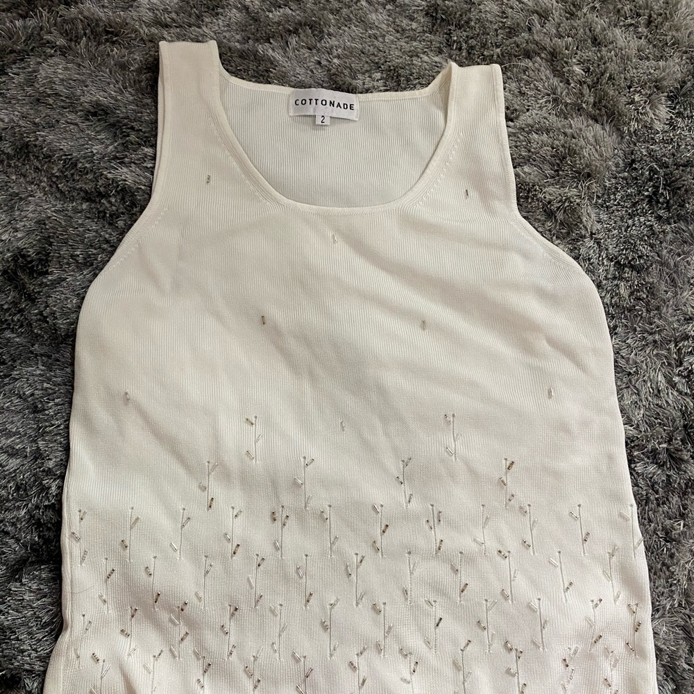 Cute white tank with some sequenced flowers